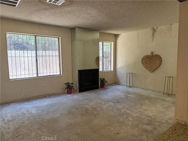 9025 Willis Ave Unit 141, Panorama City, CA 91402 - unfurnished living room with concrete floors, a fireplace, and a textured ceiling