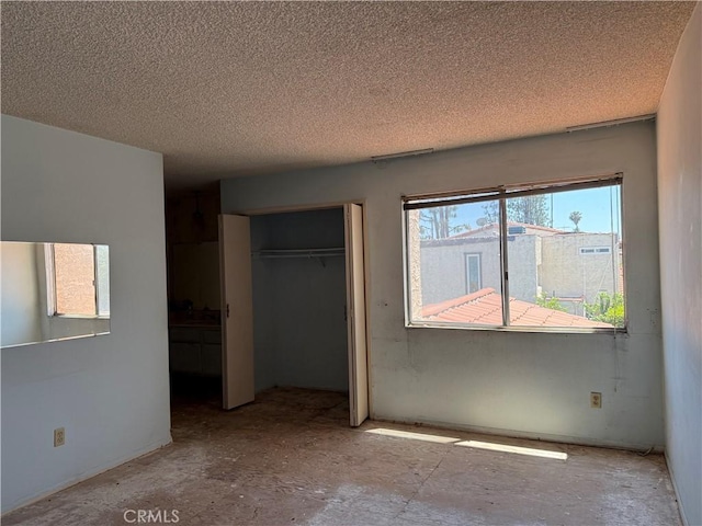 9025 Willis Ave Unit 141, Panorama City, CA 91402 - unfurnished bedroom with a closet and a textured ceiling