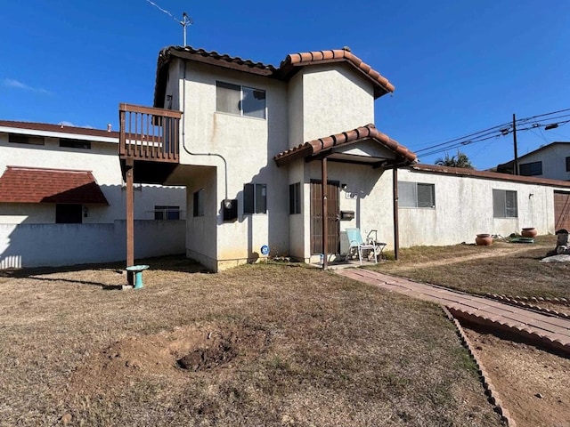 4520 Orten St, San Diego, CA 92110 - rear view of house featuring a tiled roof, stucco siding, and a balcony