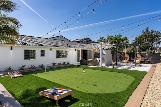 17174 Santa Madrina St, Fountain Valley, CA 92708 - rear view of house with a putting area, a pergola, and stucco siding