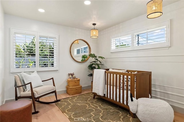 17174 Santa Madrina St, Fountain Valley, CA 92708 - bedroom featuring multiple windows, wood finished floors, recessed lighting, and a crib