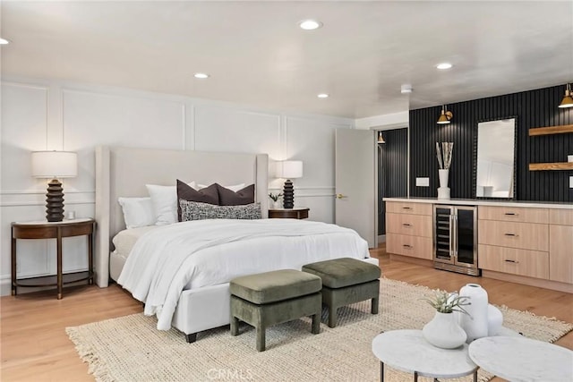 17174 Santa Madrina St, Fountain Valley, CA 92708 - bedroom featuring beverage cooler, a decorative wall, light wood-style flooring, recessed lighting, and bar area