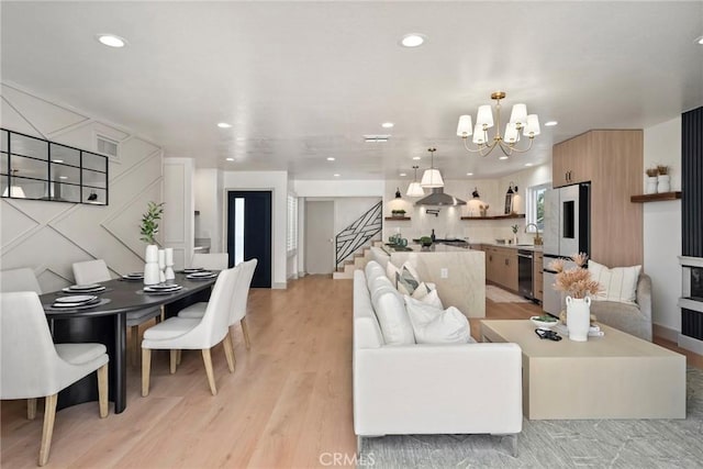 17174 Santa Madrina St, Fountain Valley, CA 92708 - living room with a chandelier, light wood-style floors, stairs, and recessed lighting