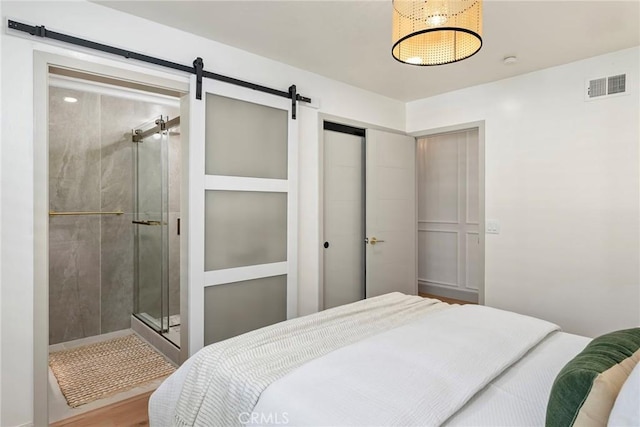 17174 Santa Madrina St, Fountain Valley, CA 92708 - bedroom with a barn door, a closet, and wood finished floors