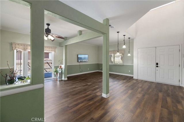 foyer with ceiling fan, healthy amount of natural light, wood finished floors, and baseboards