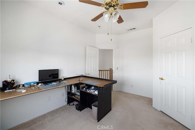 office with light carpet and a ceiling fan