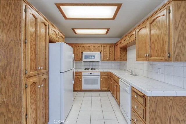 1542 E Alluvial Ave Unit 258, Fresno, CA 93720 - kitchen with white appliances, light tile patterned floors, backsplash, and tile countertops