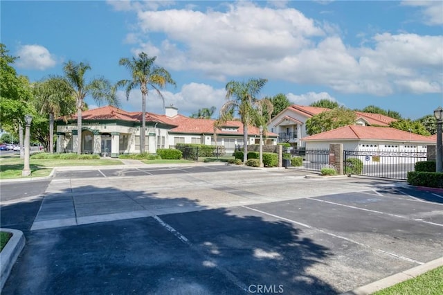 1542 E Alluvial Ave Unit 258, Fresno, CA 93720 - uncovered parking lot with a gate and a residential view