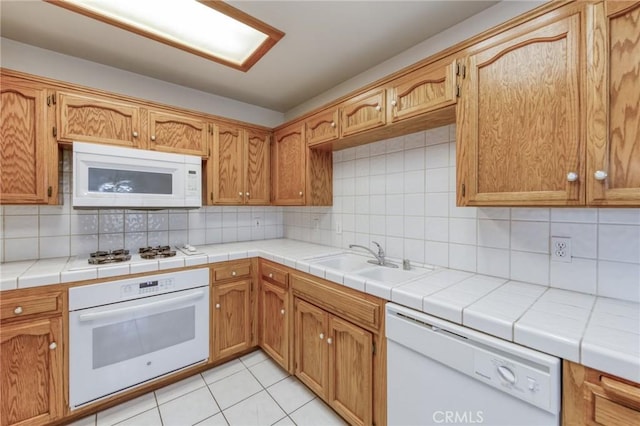 1542 E Alluvial Ave Unit 258, Fresno, CA 93720 - kitchen with white appliances, decorative backsplash, light tile patterned flooring, and light countertops