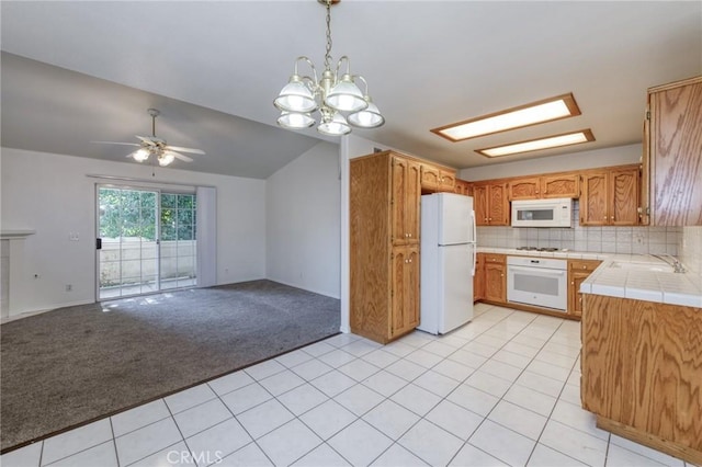 1542 E Alluvial Ave Unit 258, Fresno, CA 93720 - kitchen with white appliances, open floor plan, ceiling fan, a chandelier, and light carpet