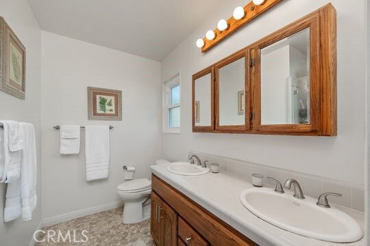 6741 Monero Dr, Rancho Palos Verdes, CA 90275 - bathroom featuring double vanity, toilet, and baseboards