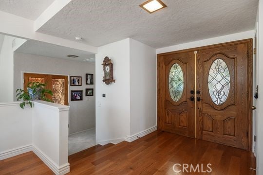 6741 Monero Dr, Rancho Palos Verdes, CA 90275 - foyer featuring wood finished floors, a textured ceiling, and baseboards