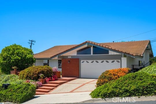 6741 Monero Dr, Rancho Palos Verdes, CA 90275 - ranch-style home with a garage, driveway, and a tile roof