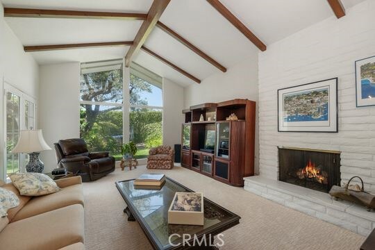 6741 Monero Dr, Rancho Palos Verdes, CA 90275 - carpeted living room featuring a brick fireplace