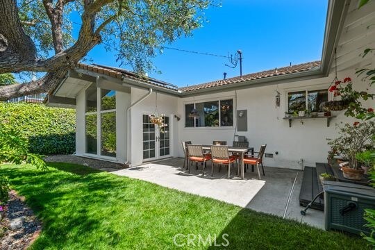 6741 Monero Dr, Rancho Palos Verdes, CA 90275 - rear view of house with stucco siding, a patio area, a yard, and french doors