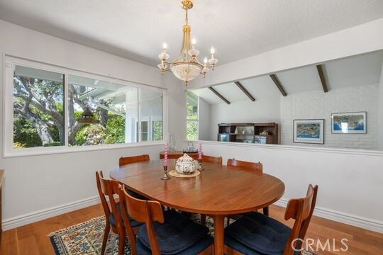 6741 Monero Dr, Rancho Palos Verdes, CA 90275 - dining space featuring a chandelier, baseboards, and wood finished floors