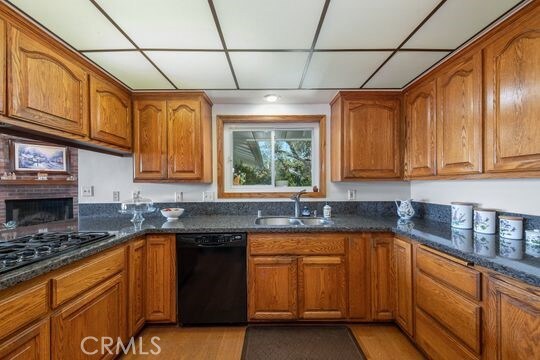 6741 Monero Dr, Rancho Palos Verdes, CA 90275 - kitchen with black appliances, a sink, brown cabinets, dark stone countertops, and a paneled ceiling
