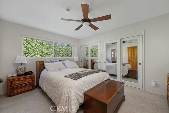 6741 Monero Dr, Rancho Palos Verdes, CA 90275 - bedroom with french doors, light colored carpet, ceiling fan, multiple closets, and baseboards