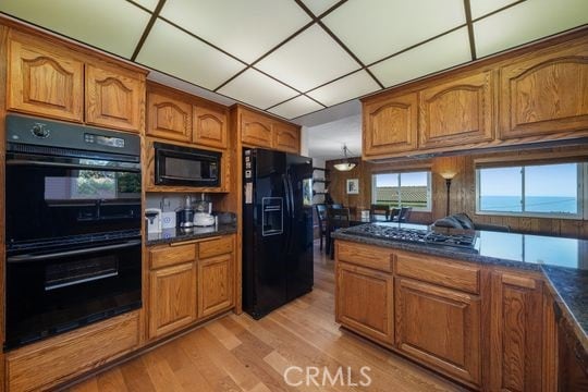 6741 Monero Dr, Rancho Palos Verdes, CA 90275 - kitchen featuring black appliances, brown cabinets, and light wood-type flooring