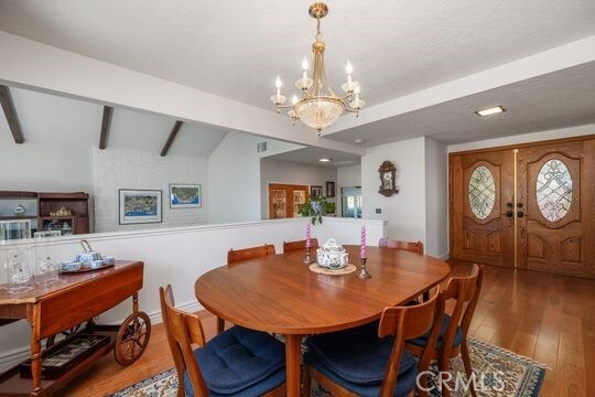 6741 Monero Dr, Rancho Palos Verdes, CA 90275 - dining room with a chandelier, wood finished floors, and baseboards