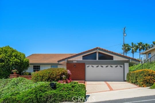 6741 Monero Dr, Rancho Palos Verdes, CA 90275 - ranch-style house with an attached garage, driveway, and a tile roof
