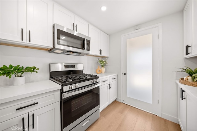 12391 Beck Ave, Garden Grove, CA 92840 - kitchen with stainless steel appliances, white cabinets, light wood-style flooring, light countertops, and recessed lighting
