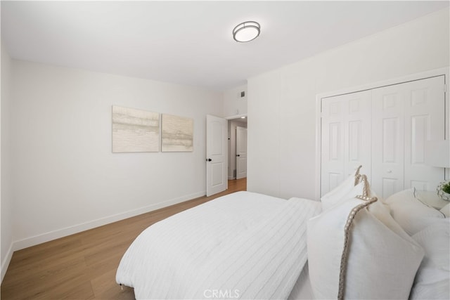 12391 Beck Ave, Garden Grove, CA 92840 - bedroom featuring wood finished floors, a closet, and baseboards