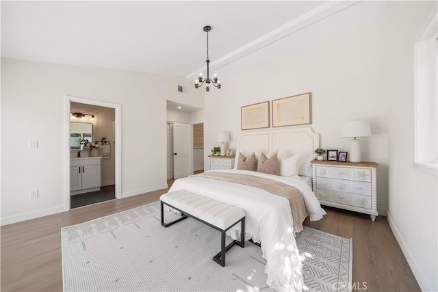 12391 Beck Ave, Garden Grove, CA 92840 - bedroom featuring a chandelier, wood finished floors, vaulted ceiling, baseboards, and connected bathroom