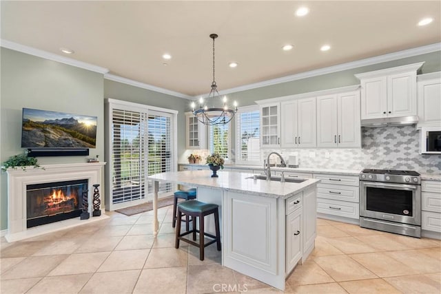 1444 Upland Hills Dr N, Upland, CA 91784 - kitchen with stainless steel gas stove, under cabinet range hood, a sink, a chandelier, and glass insert cabinets