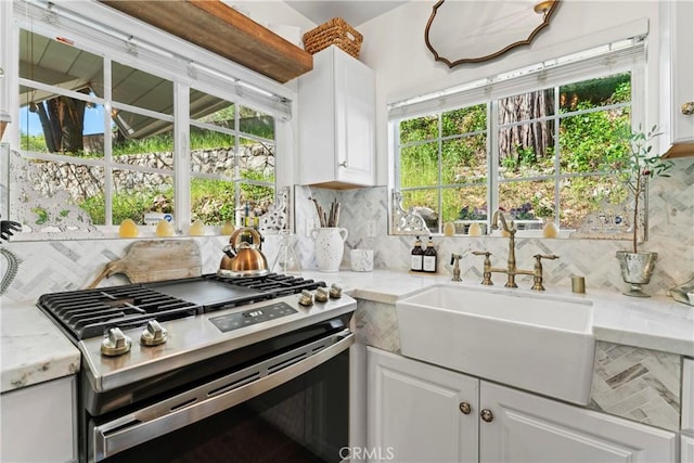 29613 Hook Creek Rd, Cedar Glen, CA 92321 - kitchen with stainless steel gas range oven, a sink, decorative backsplash, and white cabinets