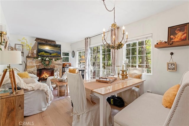 29613 Hook Creek Rd, Cedar Glen, CA 92321 - dining area with a chandelier, light wood-style flooring, and a stone fireplace