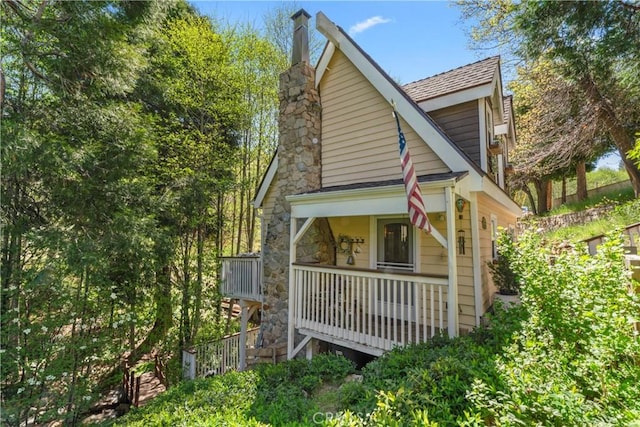 29613 Hook Creek Rd, Cedar Glen, CA 92321 - view of front of home with covered porch, roof with shingles, and a chimney