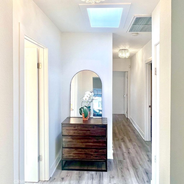 1927 W 84th Pl, Los Angeles, CA 90047 - hall featuring wood finished floors, a skylight, and baseboards