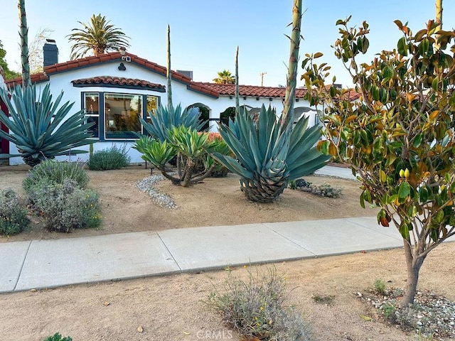1927 W 84th Pl, Los Angeles, CA 90047 - mediterranean / spanish-style home featuring a tiled roof, a chimney, and stucco siding