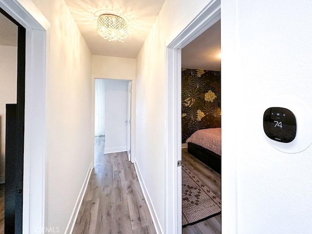1927 W 84th Pl, Los Angeles, CA 90047 - corridor featuring light wood finished floors, a chandelier, and baseboards