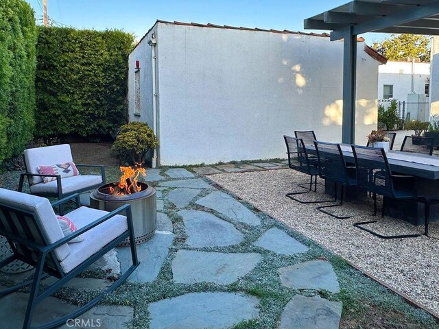 1927 W 84th Pl, Los Angeles, CA 90047 - view of patio / terrace with a fire pit and outdoor dining area