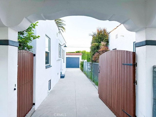 1927 W 84th Pl, Los Angeles, CA 90047 - view of side of property with a gate, stucco siding, and a garage