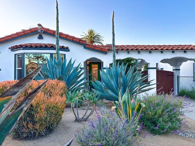 1927 W 84th Pl, Los Angeles, CA 90047 - mediterranean / spanish-style house with a tiled roof and stucco siding