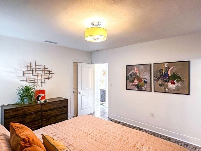 1927 W 84th Pl, Los Angeles, CA 90047 - bedroom featuring baseboards and wood finished floors