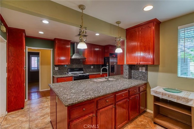 10049 Langdon, Mission Hills San Fernando, CA 91345 - kitchen with gas range oven, wall chimney exhaust hood, dark brown cabinets, a peninsula, and decorative backsplash