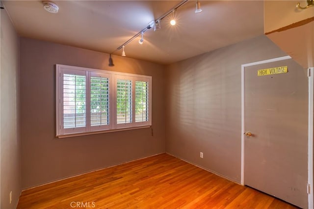 10049 Langdon, Mission Hills San Fernando, CA 91345 - empty room featuring track lighting, wood finished floors, and a smoke detector