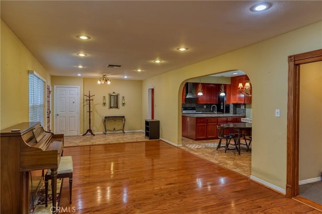 10049 Langdon, Mission Hills San Fernando, CA 91345 - living room with arched walkways, light wood-type flooring, and recessed lighting