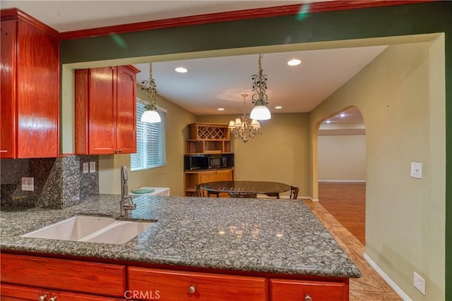 10049 Langdon, Mission Hills San Fernando, CA 91345 - kitchen featuring arched walkways, dark stone counters, pendant lighting, and recessed lighting