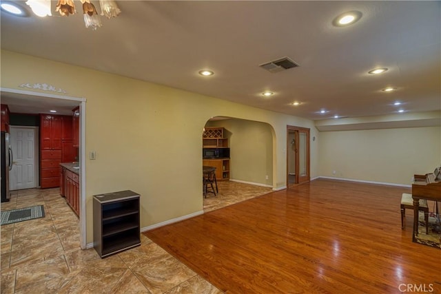 10049 Langdon, Mission Hills San Fernando, CA 91345 - living area featuring arched walkways, light wood-style floors, recessed lighting, and a chandelier