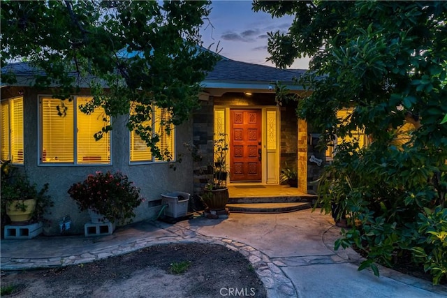 10049 Langdon, Mission Hills San Fernando, CA 91345 - exterior entry at dusk with roof with shingles and stucco siding