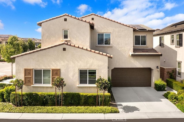 16075 Osprey Ave, Chino, CA 91708 - mediterranean / spanish-style home featuring a tiled roof, an attached garage, stucco siding, and driveway