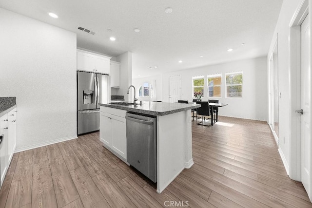 16075 Osprey Ave, Chino, CA 91708 - kitchen with stainless steel appliances, a sink, light wood-style flooring, recessed lighting, and white cabinetry