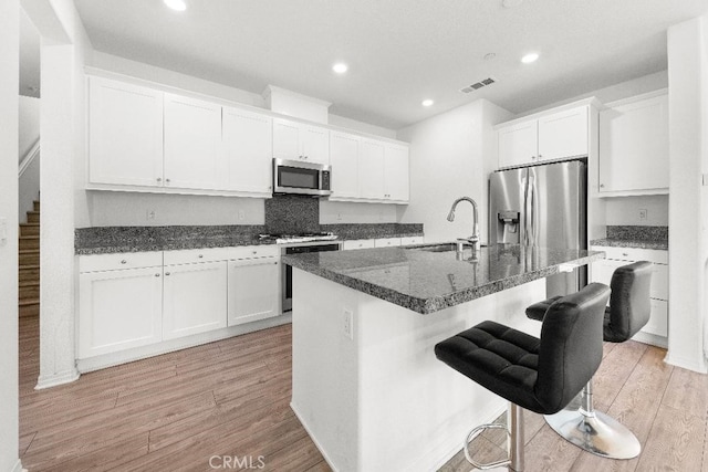 16075 Osprey Ave, Chino, CA 91708 - kitchen featuring stainless steel appliances, a sink, light wood-style floors, recessed lighting, and white cabinets