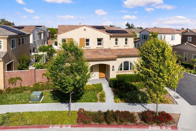 16075 Osprey Ave, Chino, CA 91708 - mediterranean / spanish house featuring a residential view, stucco siding, and roof mounted solar panels