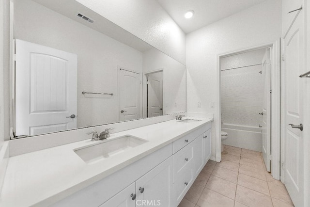 16075 Osprey Ave, Chino, CA 91708 - full bath with toilet, double vanity, tile patterned flooring, and washtub / shower combination